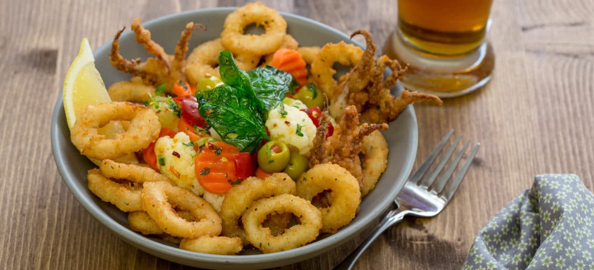 Fried Calamari Topped with Marinated Vegetables and Fried Spinach