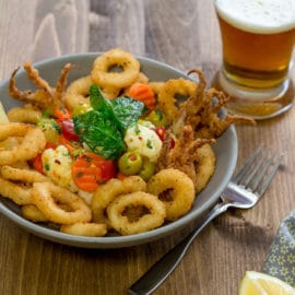 Fried Calamari Topped with Marinated Vegetables and Fried Spinach